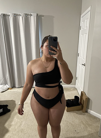 reviewer wearing the bathing suit in black