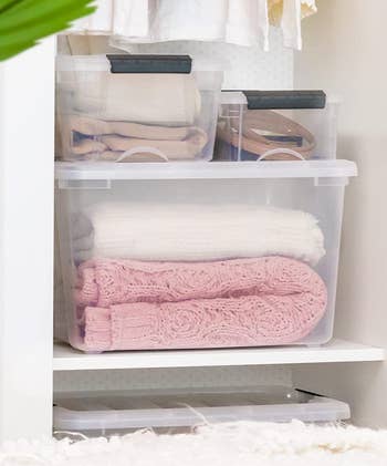 lifestyle image of clear plastic storage boxes in a closet