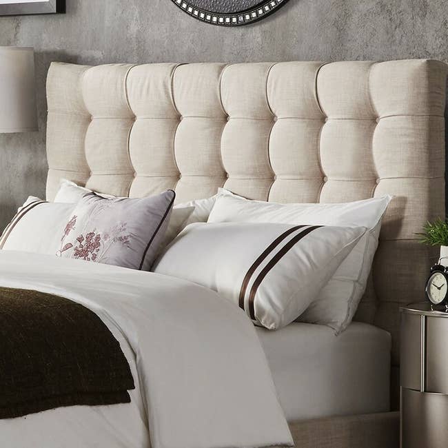 the upholstered headboard in cream