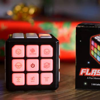 A rubiks cube-shaped light up game with buttons for control 