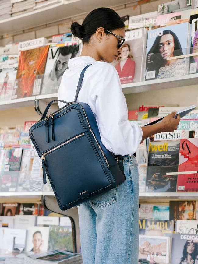 model wearing the navy blue backpack