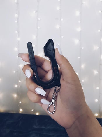 reviewer holding the car seat key in black