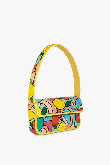 the yellow handbag with beaded lemons and other colors all over it