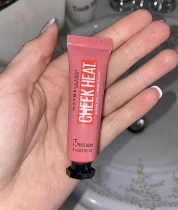 Reviewer holding product in hand