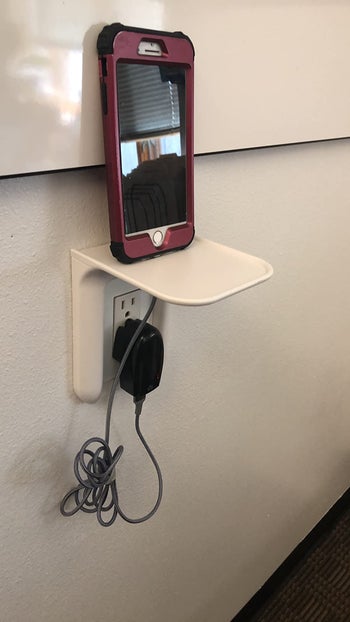 A phone on the shelf while charging