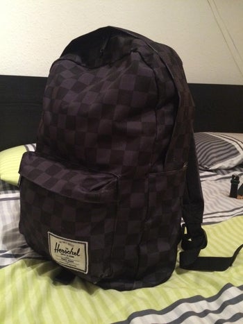 reviewer photo of black checkered Herschel mini backpack