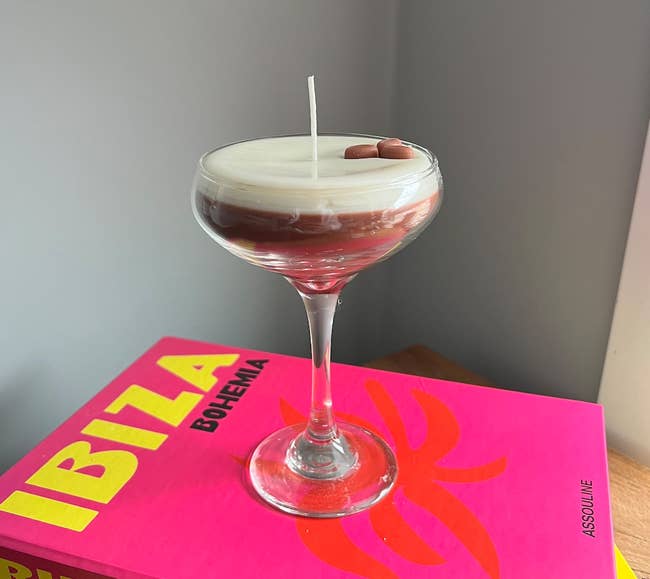 A candle shaped like an espresso martini in a stemmed glass 