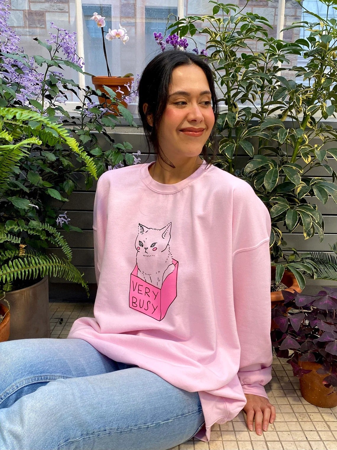 a model wearing a pink shirt that says