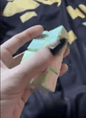 a gif of someone playing with an infinity cube