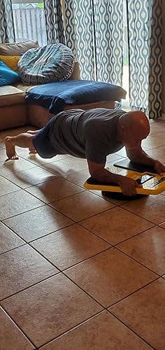 reviewer utilizing a equilibrium trainer for exercise, suggesting fittingness instrumentality for at-home workouts