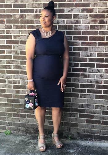 pregnant reviewer wearing dress with heels outside