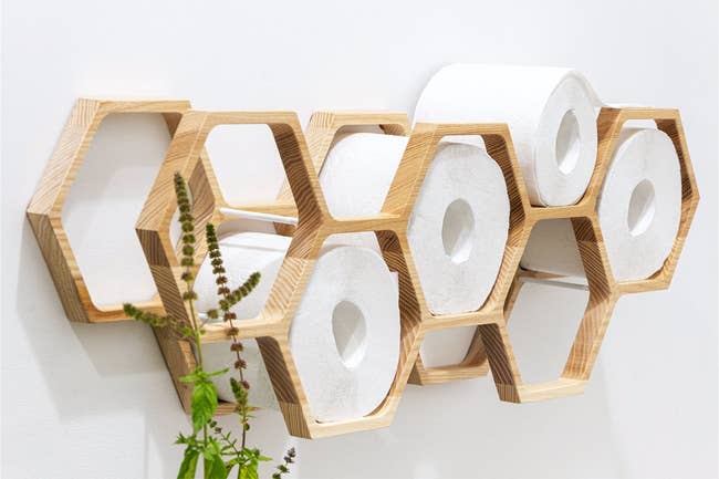 honeycomb like wooden structure with toilet paper rolls in it