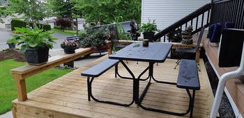 reviewer photo of black picnic table on front porch