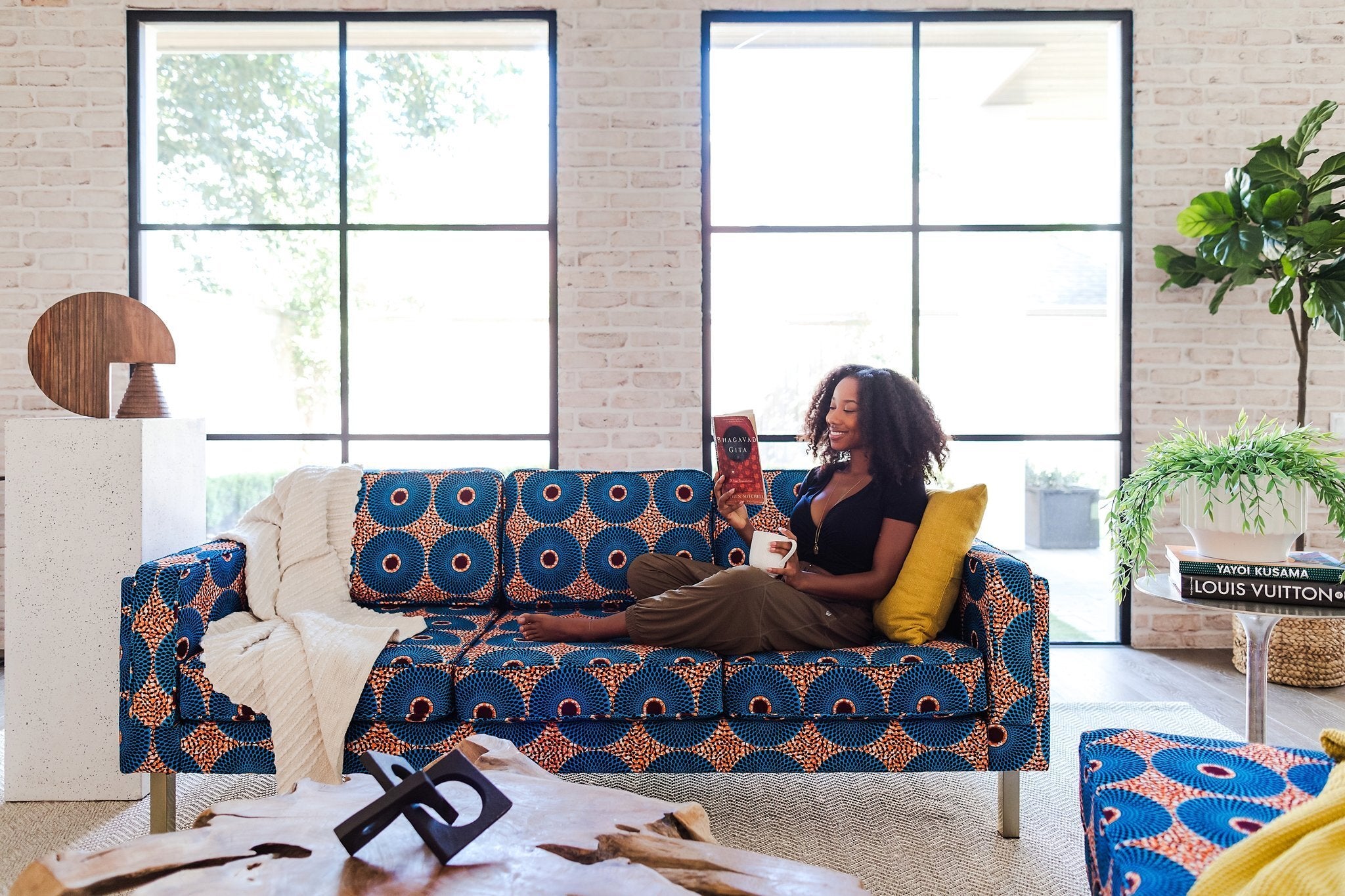 model lounging on a sofa with a Nigerian-inspired pattern 