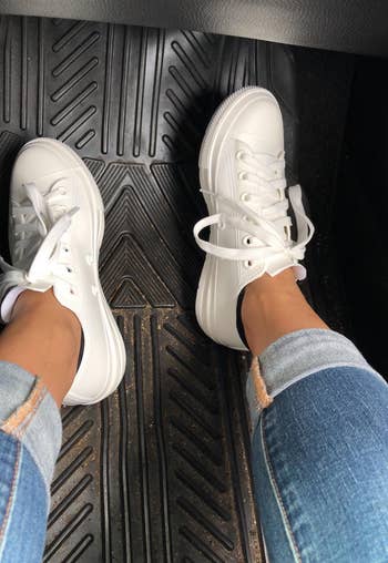 reviewer in white low tops
