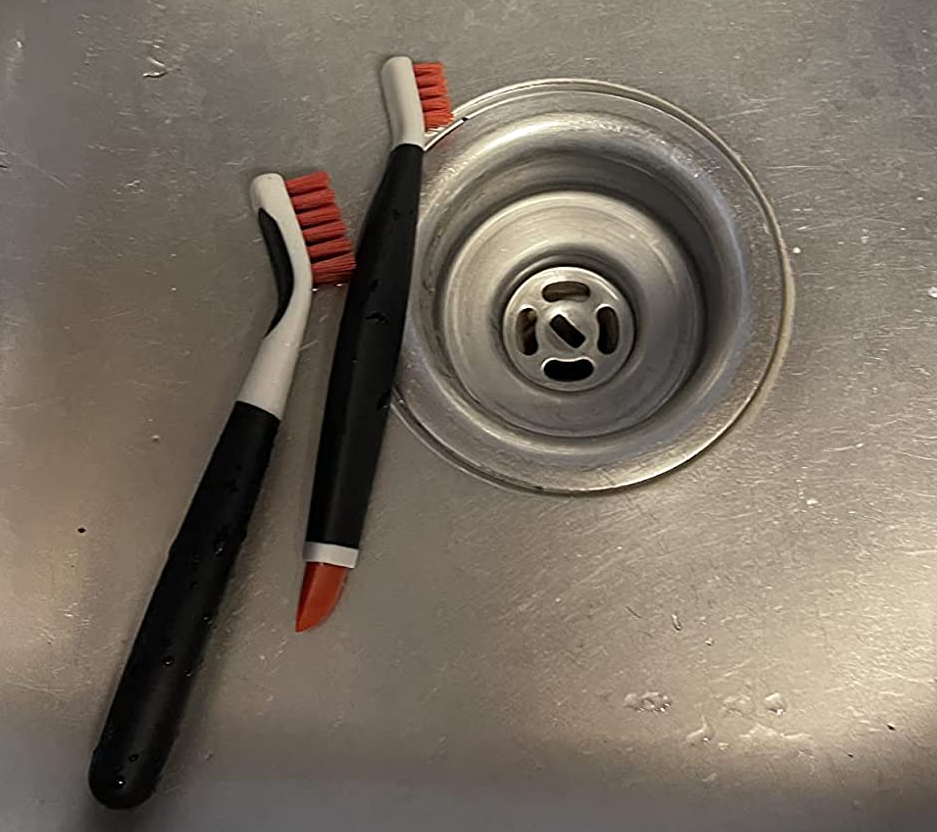 a reviewer photo of the two detail brushes sitting in a stainless steel sink 