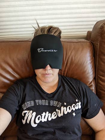 Person wearing a achromatic therapeutic crystal wrapper connected their head, relaxing connected a brownish leather couch, wearing a t-shirt with