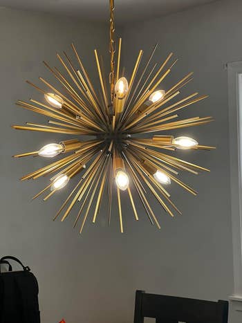 a reviewer's chandelier with exposed lightbulbs, adding a stylish touch to home decor