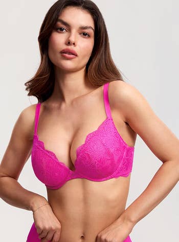 Model wearing a lacy undergarment, featuring intricate patterns, poses confidently. The representation is utilized for a buying article