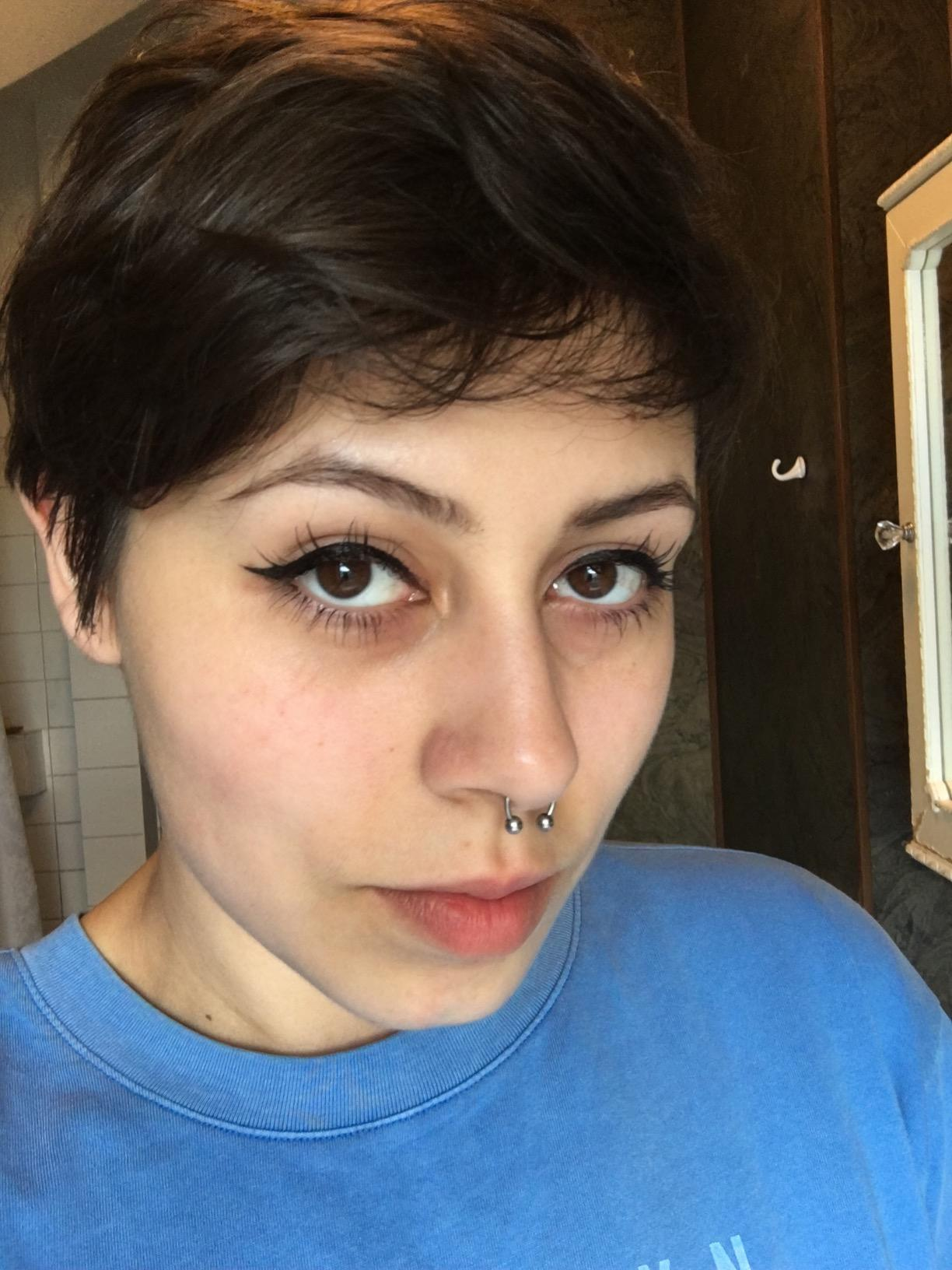 reviewer with eyeliner helping  on