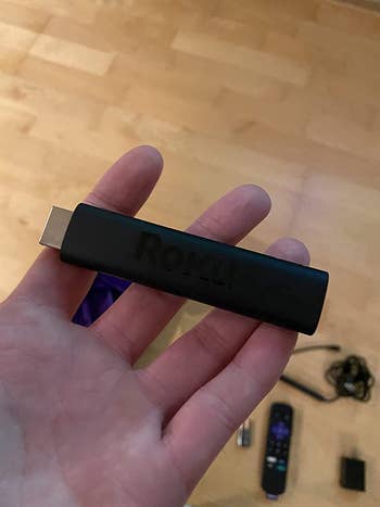 Reviewer holding the Roku stick