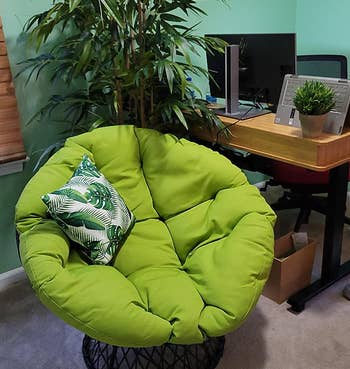 Reviewer image of green chair with green and white throw pillow