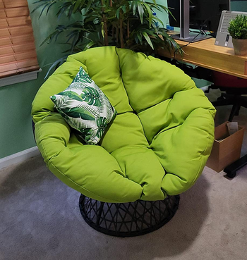 Reviewer image of green chair with green and white throw pillow