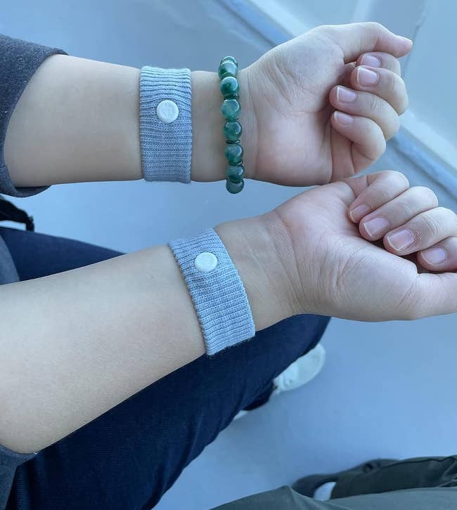 reviewer wearing a Sea Band on each wrist