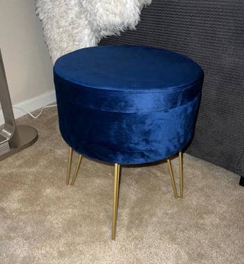 a reviewer photo of the ottoman in navy blue 