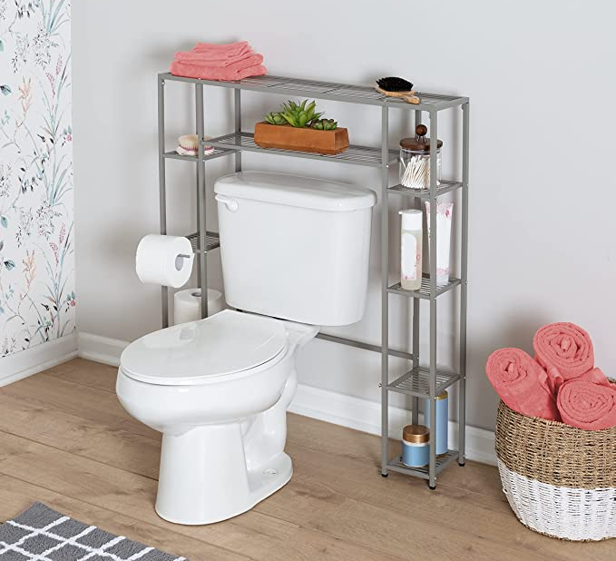 Silver over the toilet storage with 10 shelves in front of a white wall 