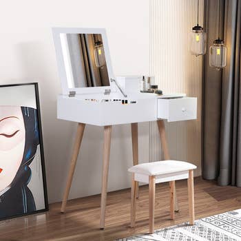 the same desk open as a vanity mirror and storage inside