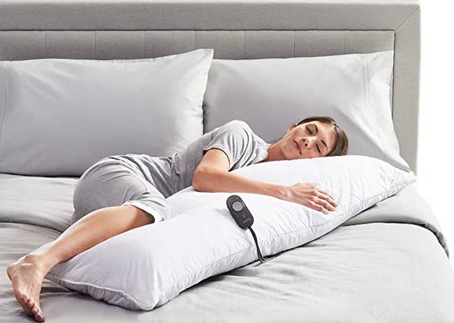model sleeping on heated body pillow
