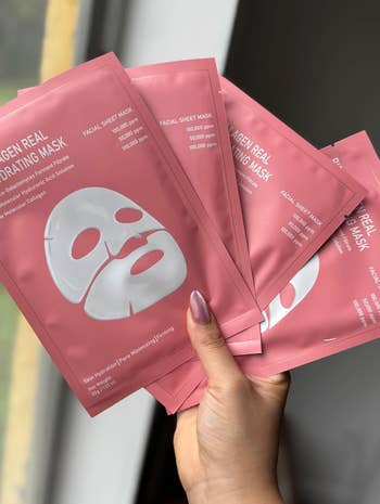 A manus  holds aggregate  pinkish  collagen facial expanse  disguise  packages adjacent   a window, promoting skincare and hydration