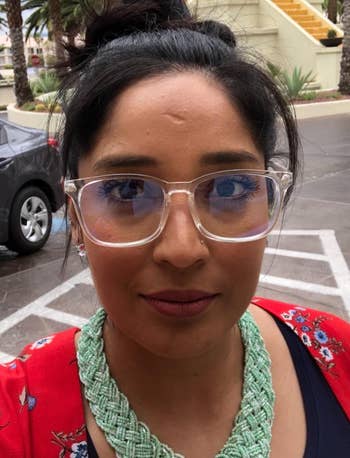reviewer wearing the clear blue light-blocking glasses