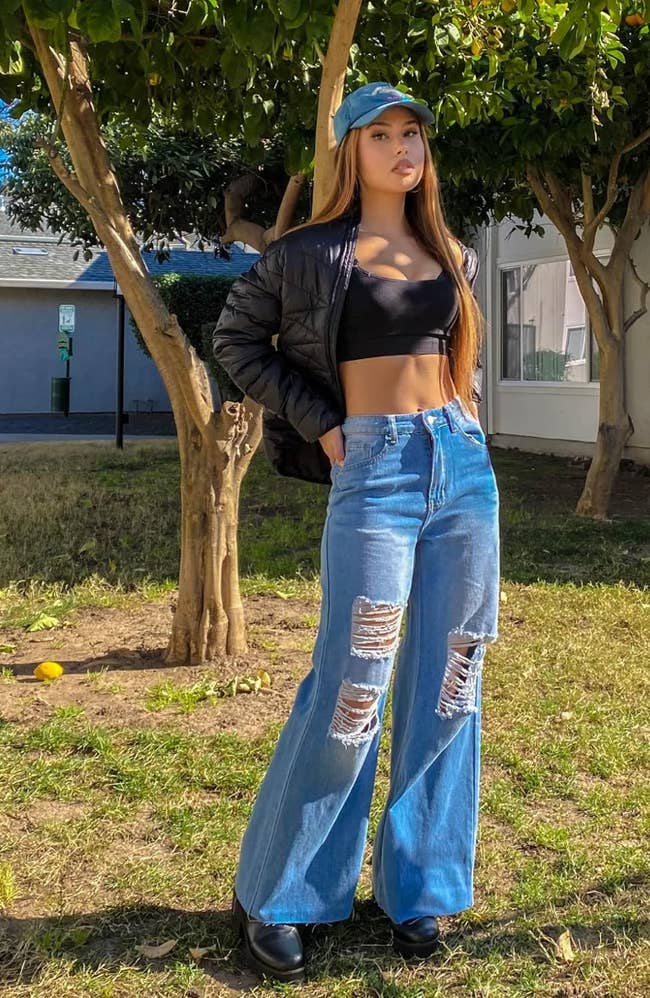 reviewer posing in loose ripped high-waisted jeans