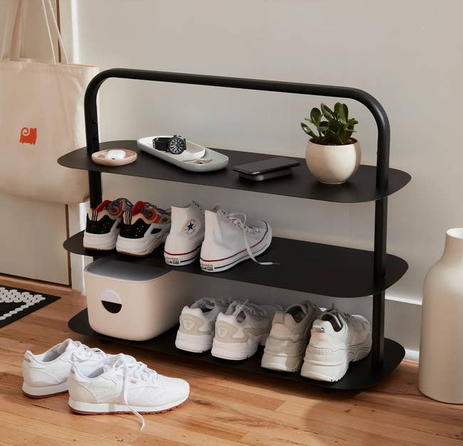 the black rack with shoes on it 