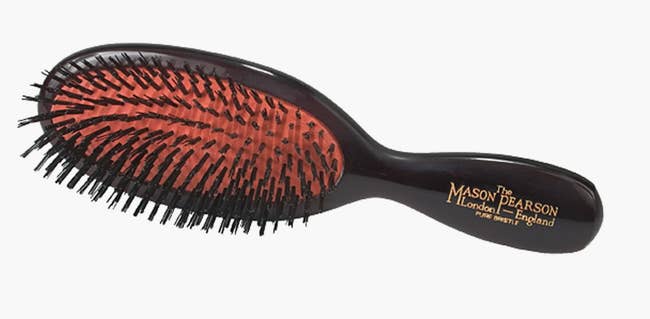 Mason Pearson hairbrush with black bristles and an ergonomic handle