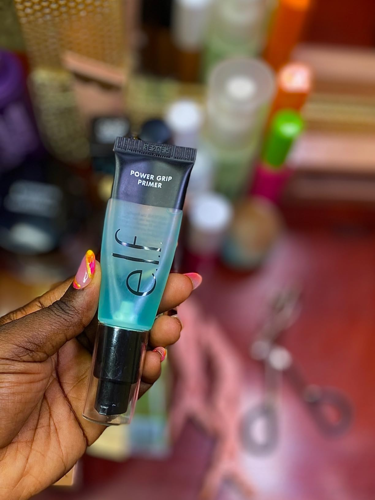 Reviewer holding e.l.f powerfulness  grip primer