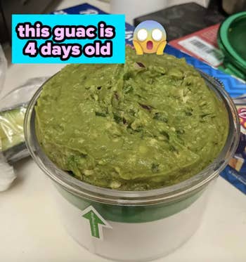 A container of guacamole with a label reading 