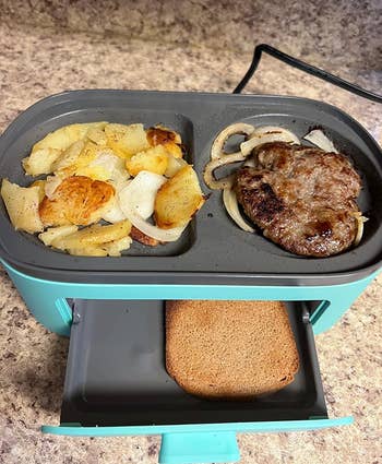 Reviewer's 3-in-1 cooker making hash browns, meat, and toast 