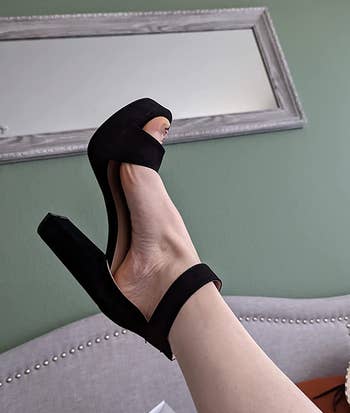 reviewer's foot in the black pump