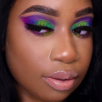 model with a purple, green, and pink eyeshadow look