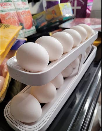 Two tiered egg dispenser holding a dozen eggs, six on each tier 