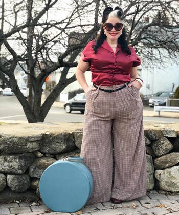 another reviewer wearing the brown plaid pants with a red top