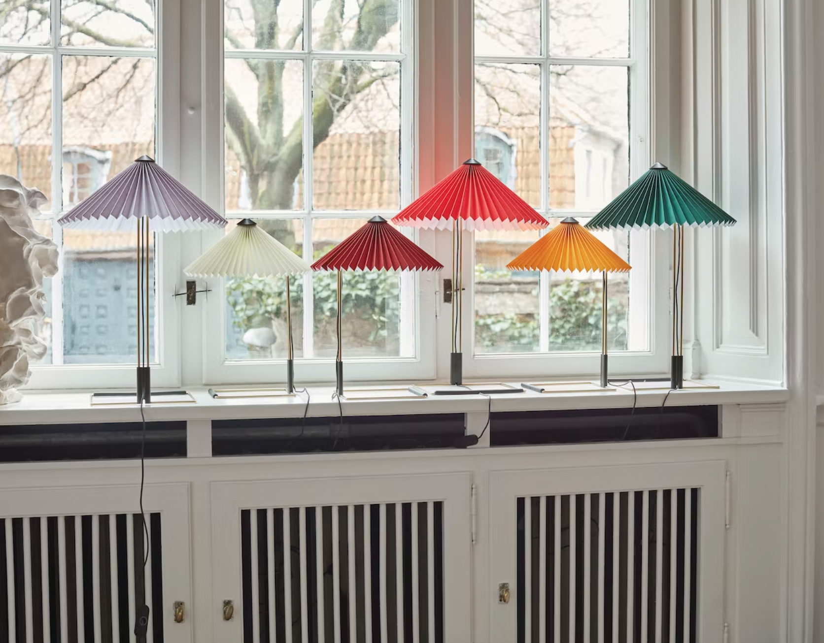 several origami lamps on a windowsill