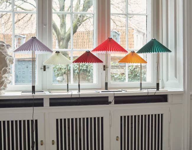 several origami lamps on a windowsill 