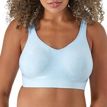 Person wearing a seamless bra with a subtle floral pattern in light blue