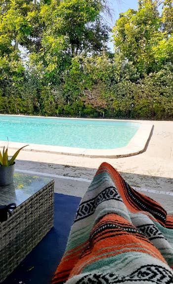 reviewer covered in blanket by pool