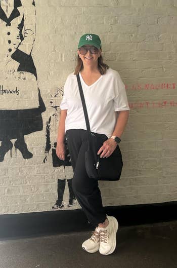 Woman successful casual attire poses adjacent to thoroughfare creation of a fig holding an umbrella, resembling a classical nanny character