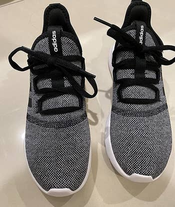 a top-down view of the knit sneakers in dark gray with black laces 